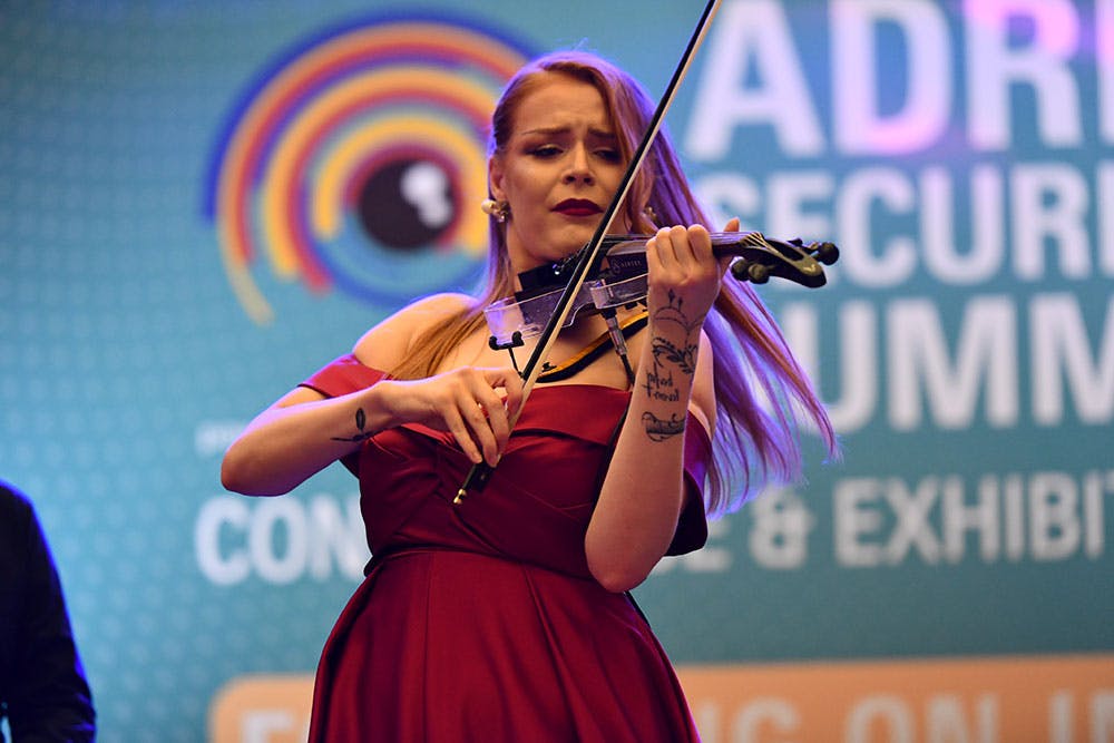 A violinist creates music against in Adria security summit
